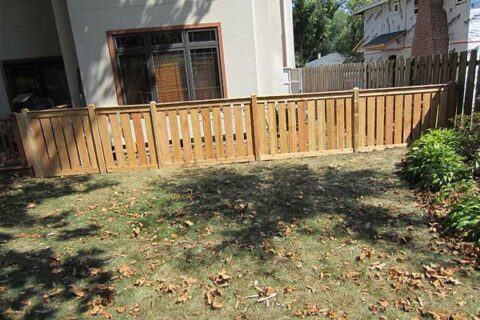 A wooden fence surrounds a backyard in Batavia, IL, enhancing the home's outdoor aesthetics