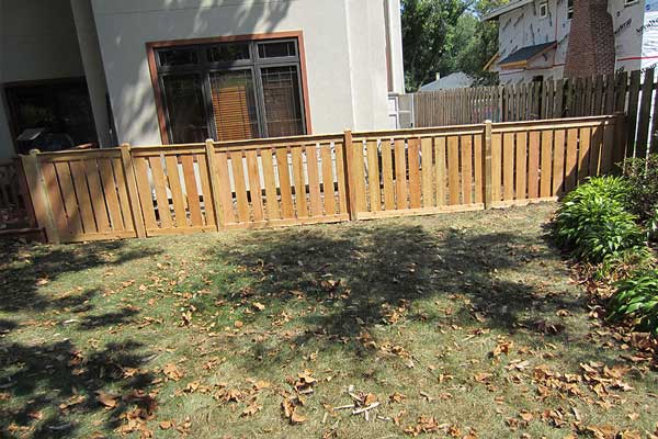 A wooden fence surrounds a backyard in Batavia, IL, enhancing the home's outdoor aesthetics
