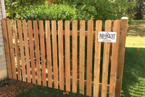 A wooden fence with a sign, located in Batavia, IL
